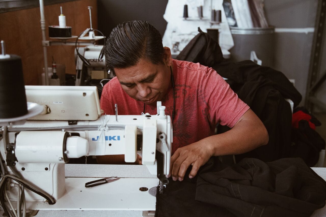 Sewing expert working on garment