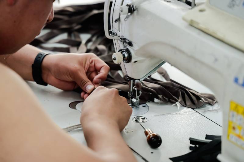 Closeup of patternmaker using sewing machine