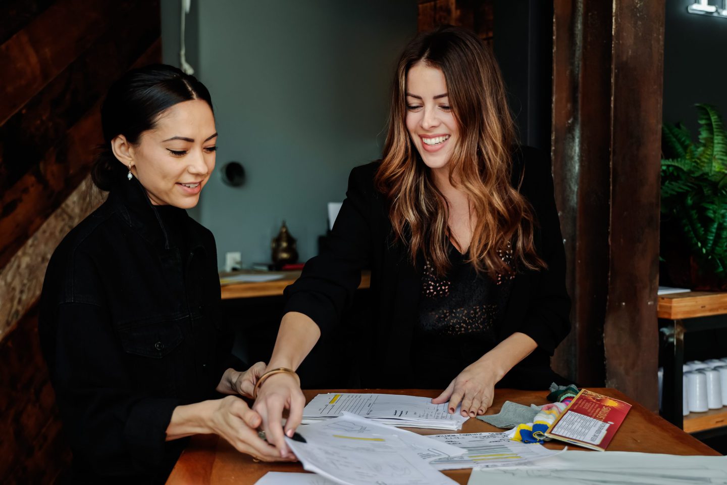 Two fashion designers helping design your own clothing