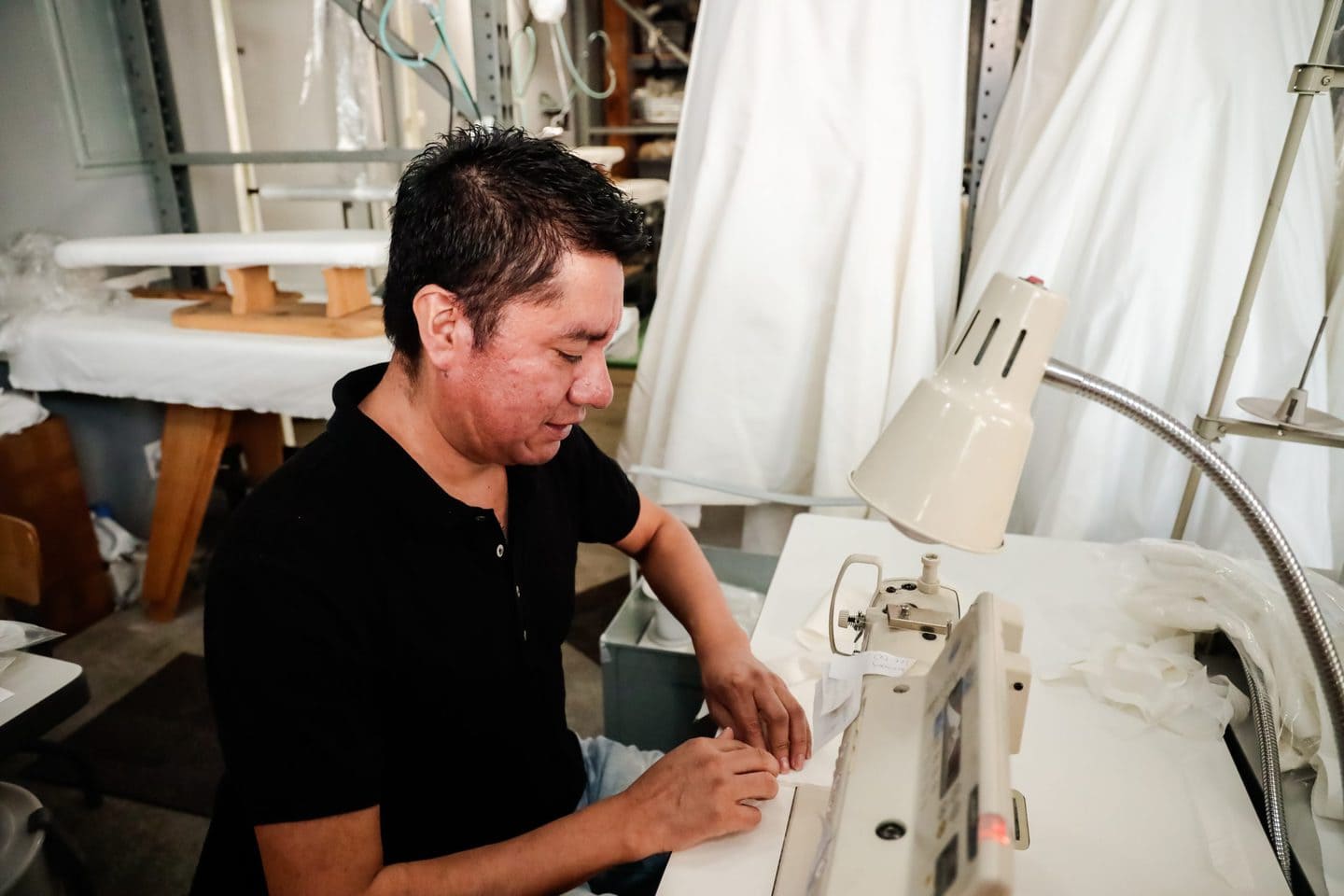 Los Angeles clothing sample maker working at the sewing machine
