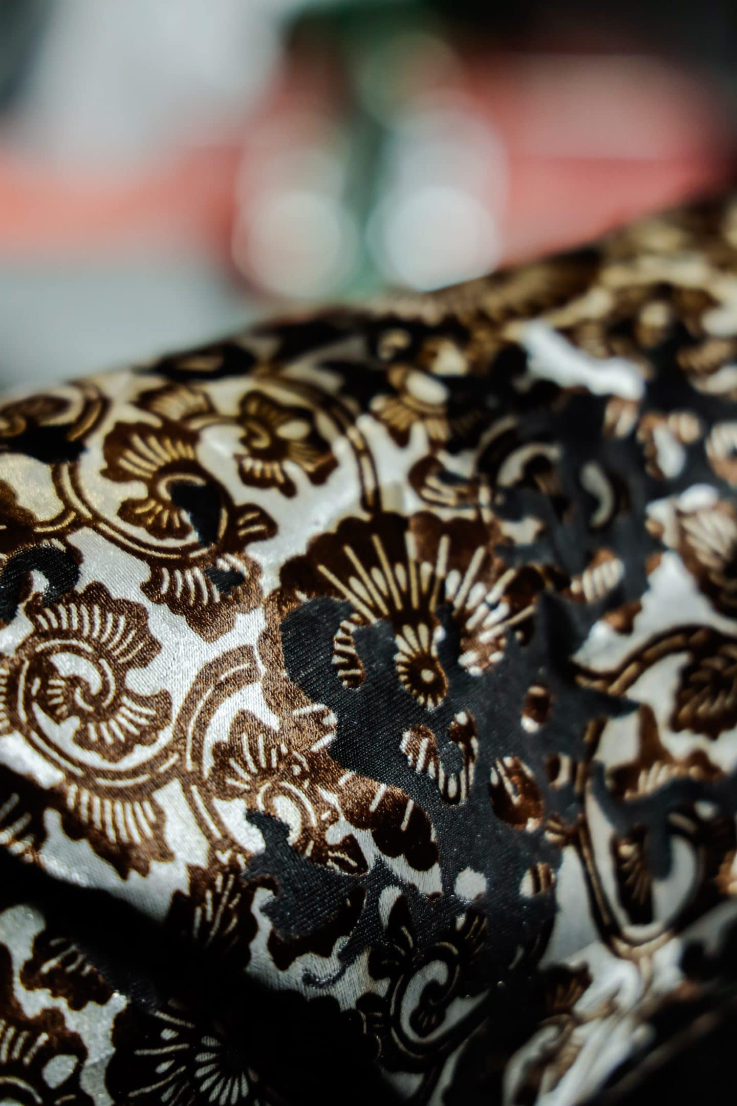 closeup of detailed white, black, and brown fabric design used by pattern makers in slow fashion