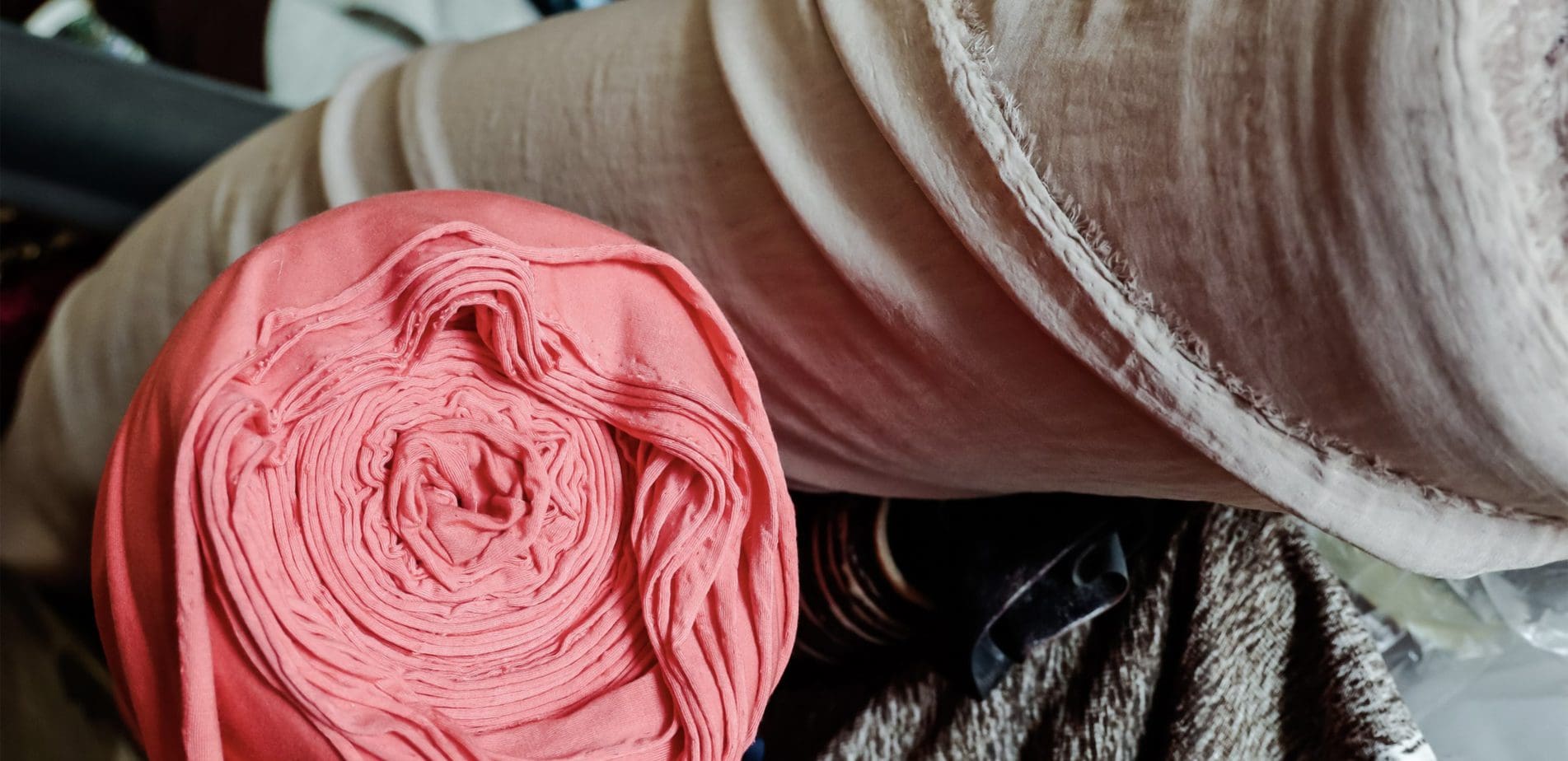 pink and white reams of fabric used in spring 2022 fashion trends