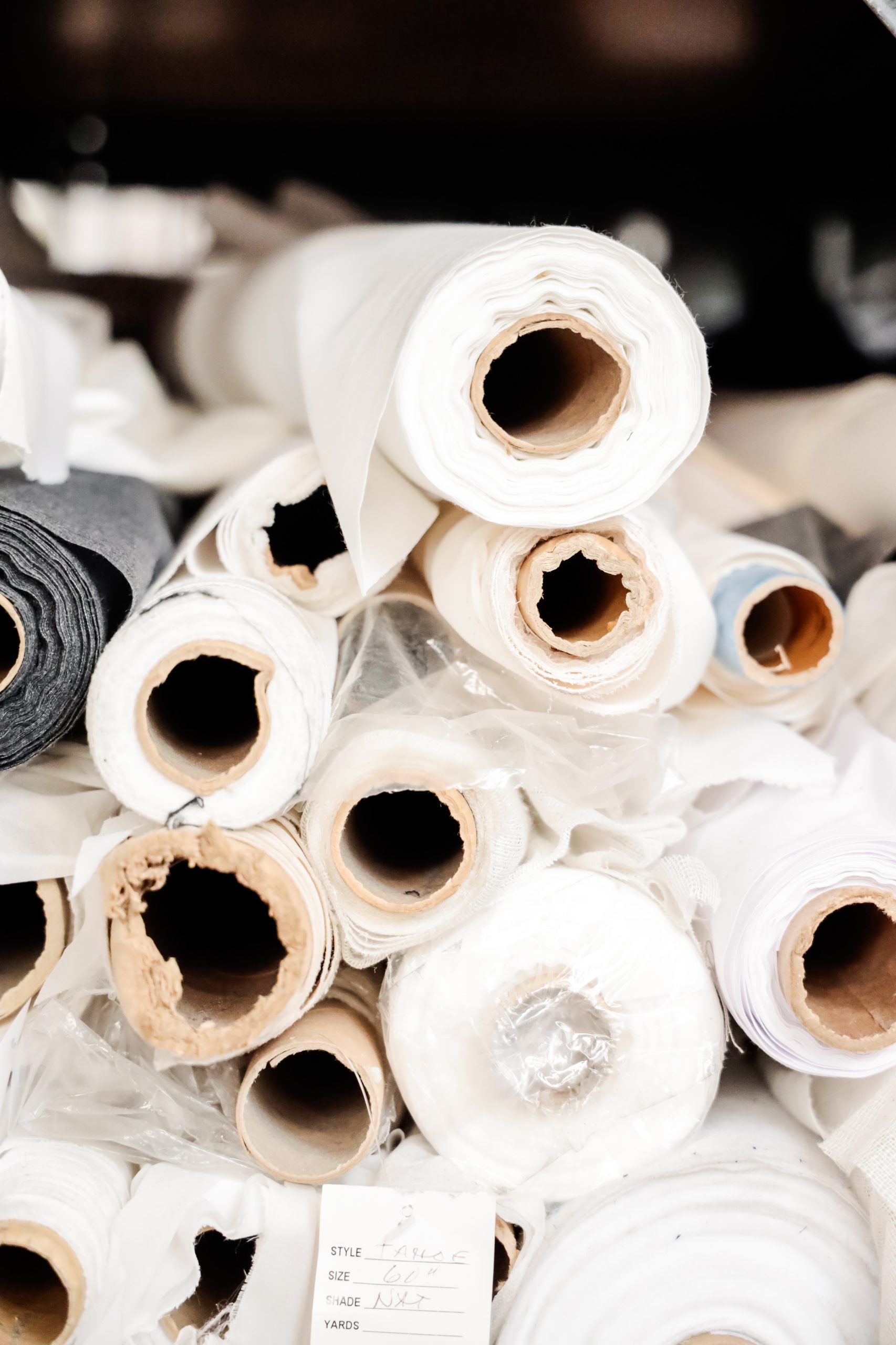 large stack of white fabric rolls